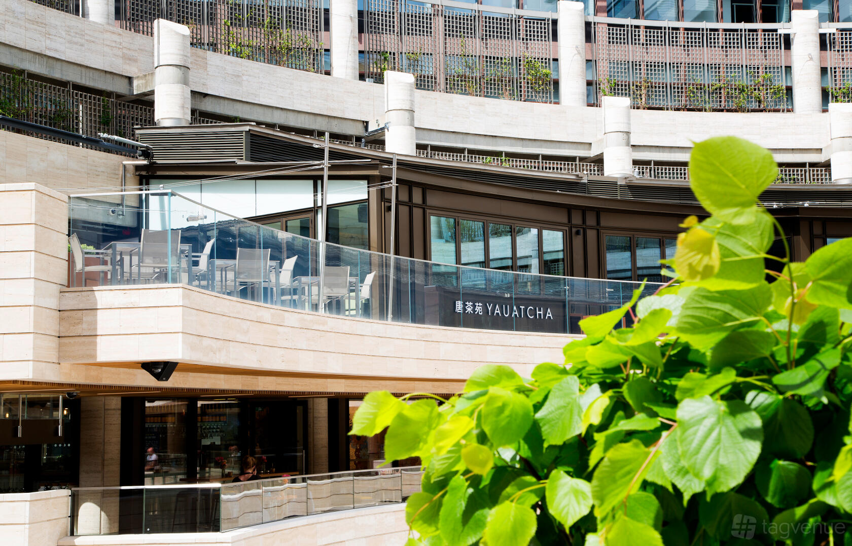 A restaurant with an outdoor terrace seating area behind glass railings at Yauatcha City.