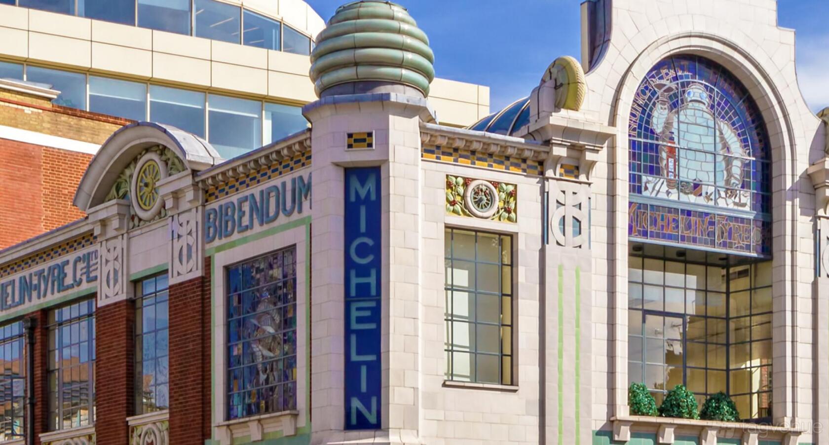 An art nouveau building with decorative tiles and a glass dome at Michelin House.