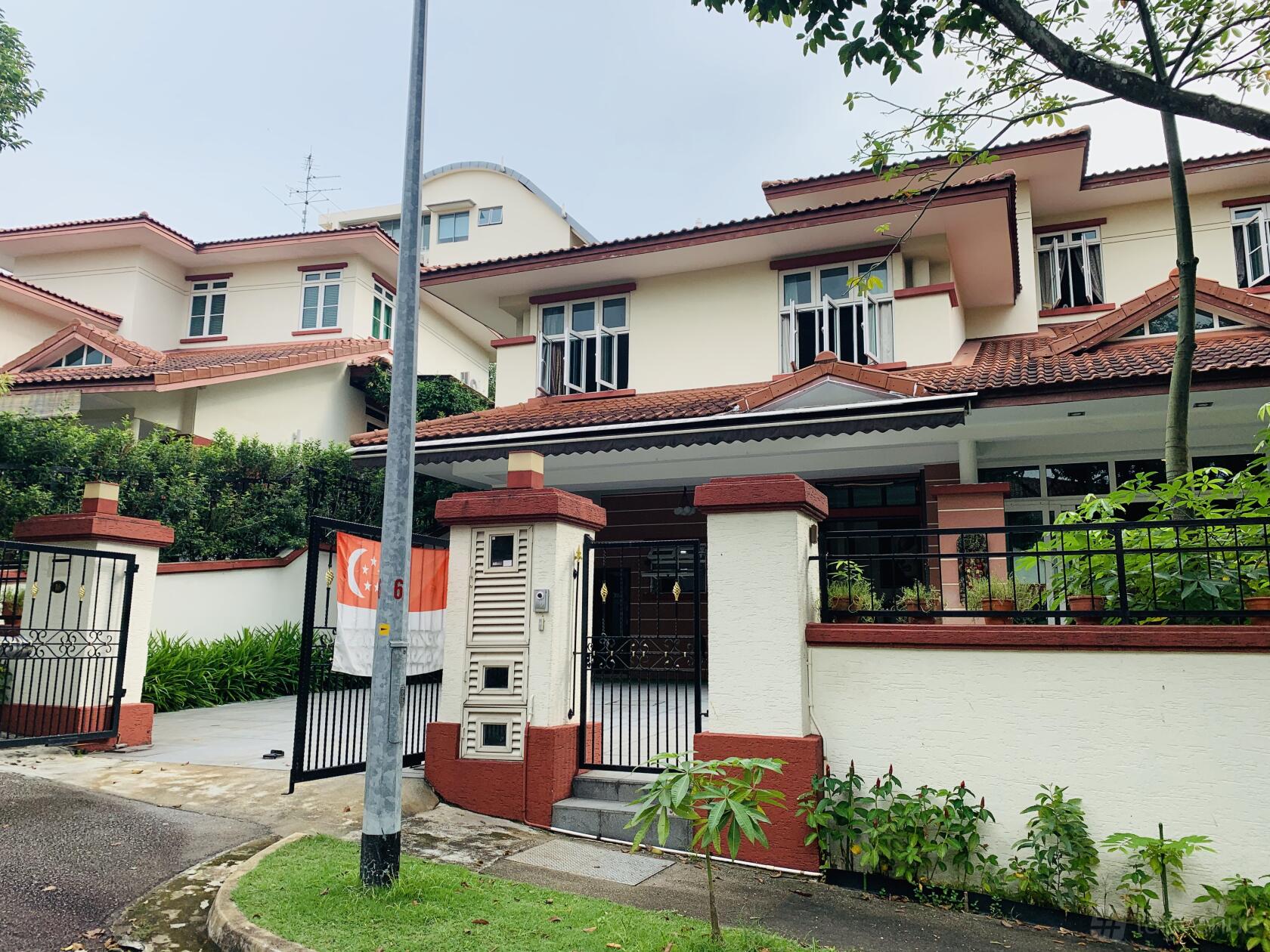 A two-story bungalow with a gated entrance, tiled roof, and landscaped greenery at Bungalow/Landed Property.