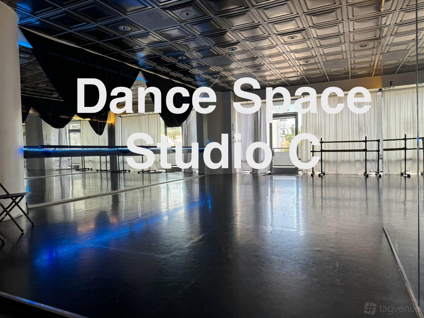A dance studio with floor-to-ceiling mirrors, ballet barres, and large windows at Dance Space Studio C.