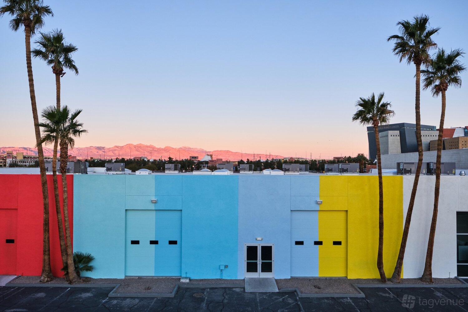A blank canvas venue with a colorful exterior featuring blue, yellow, and white painted walls at Nine Twenty.