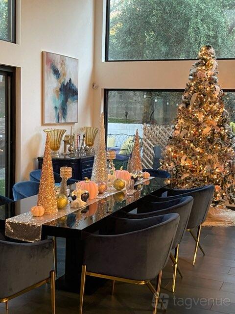 A restaurant with a decorated dining table featuring glittering ornaments and a Christmas tree at Backyard Bliss.