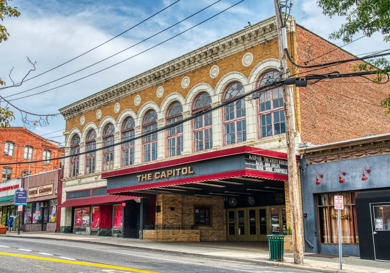 A historic theatre with arched windows, detailed brickwork, and a marquee entrance at The Capitol Theatre.
