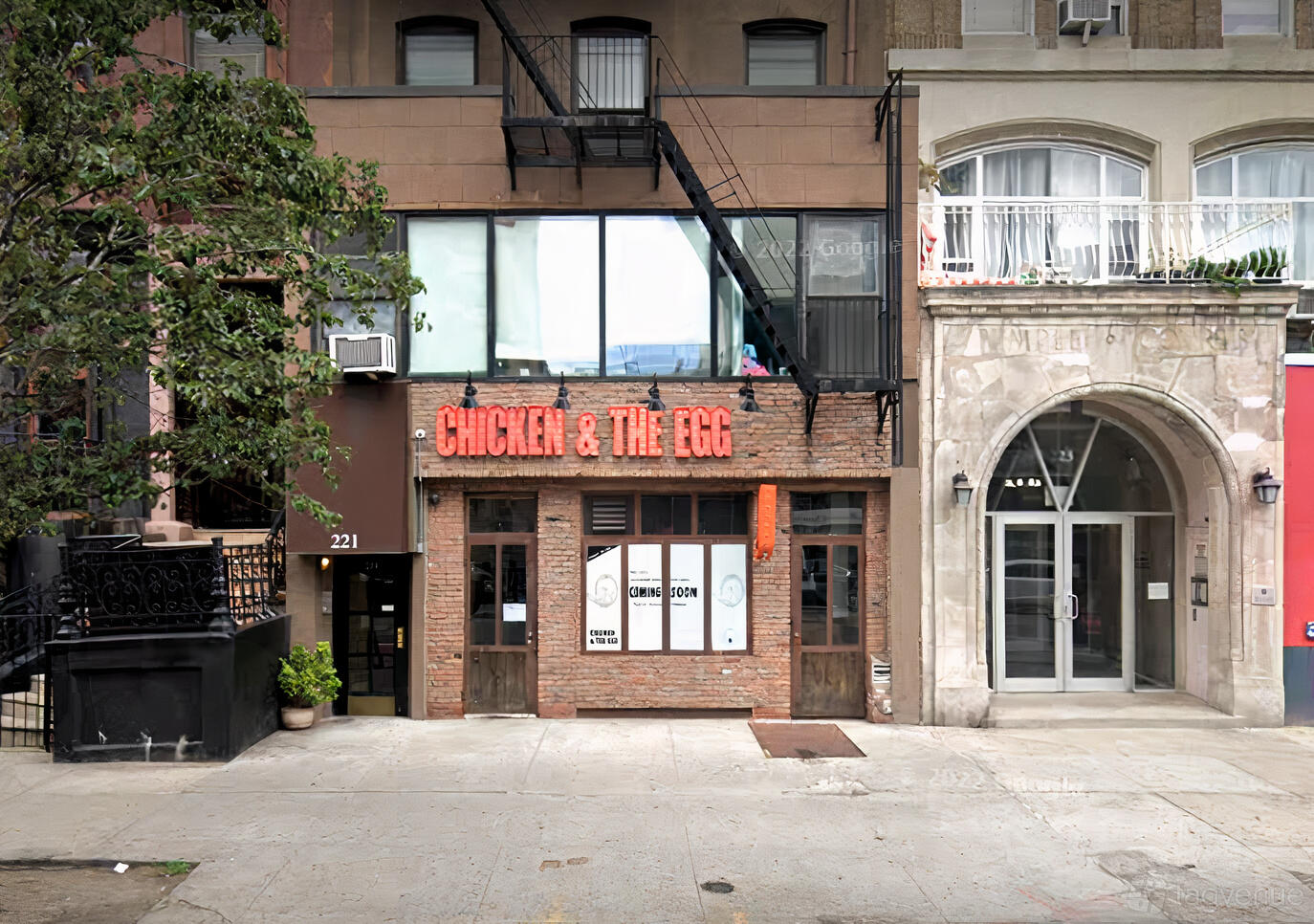 A pub with a brick facade, large windows, and a red neon sign at Sincerely, Ophelia.