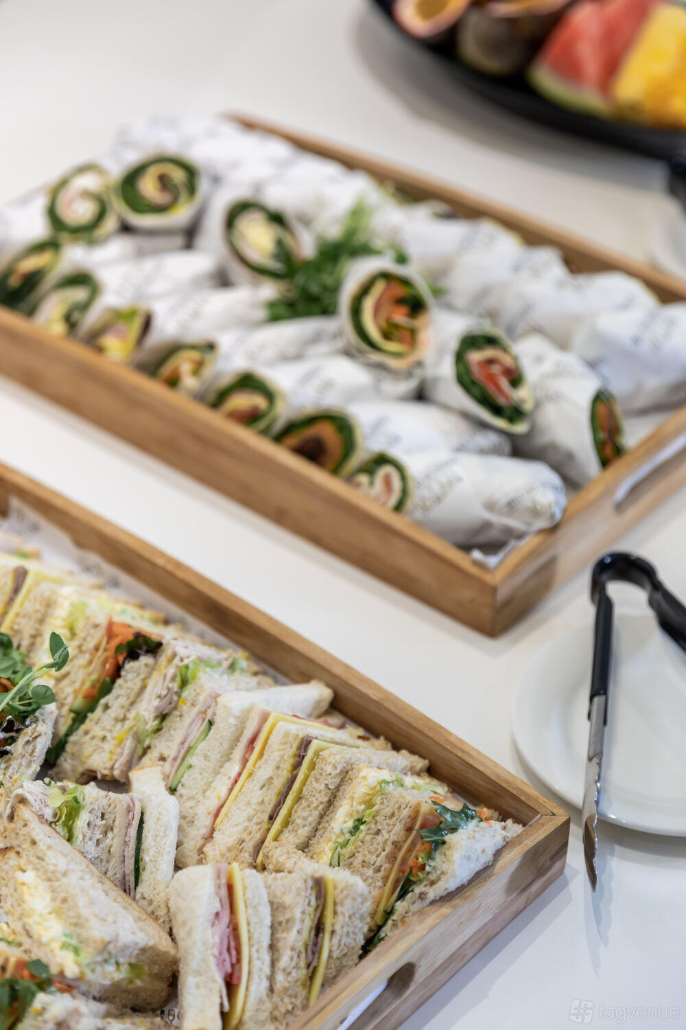 A coworking space with assorted sandwiches and wraps on wooden trays at Christie Spaces Conferencing Brisbane.