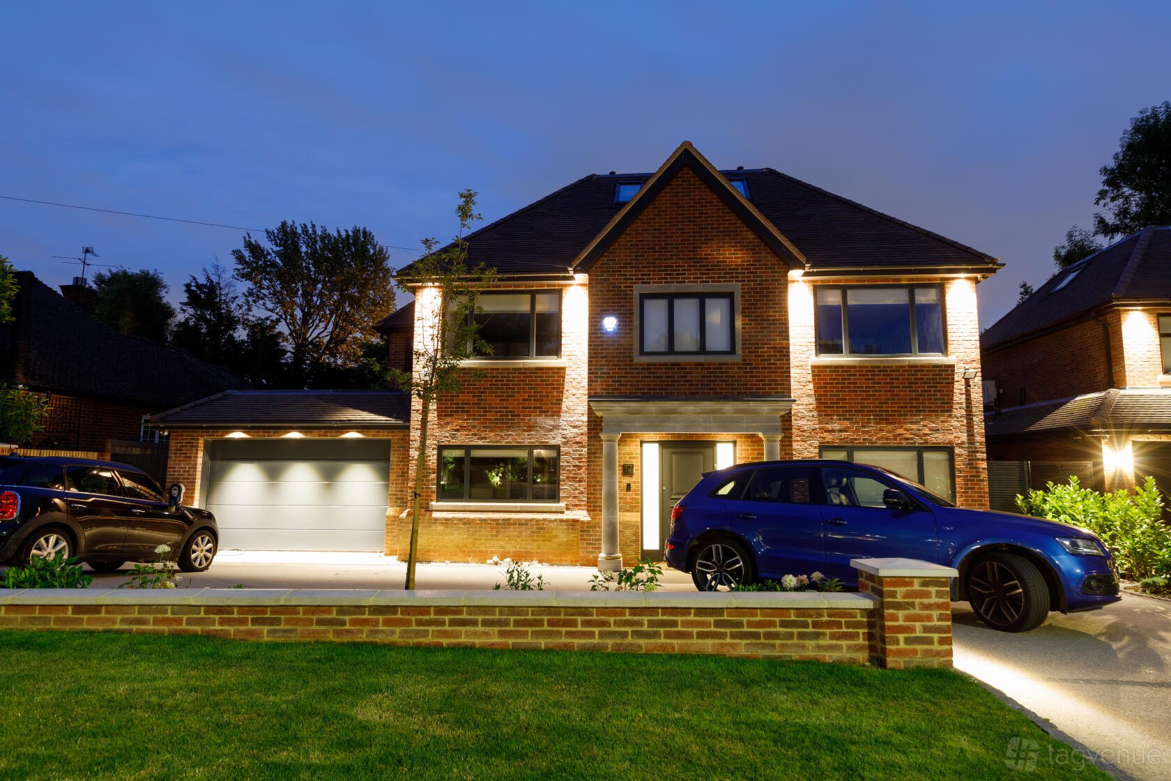 A brick blank canvas venue with large windows, front lawn, and driveway at Valencia.