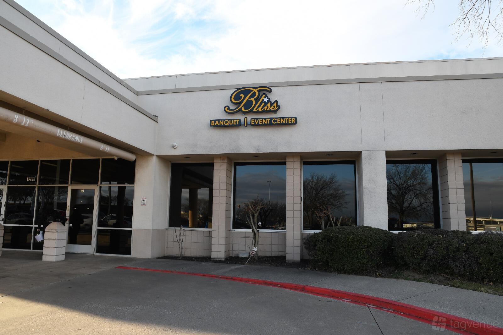 An event center exterior with large windows, cream facade, and Bliss signage at Bliss Pavilion 1.