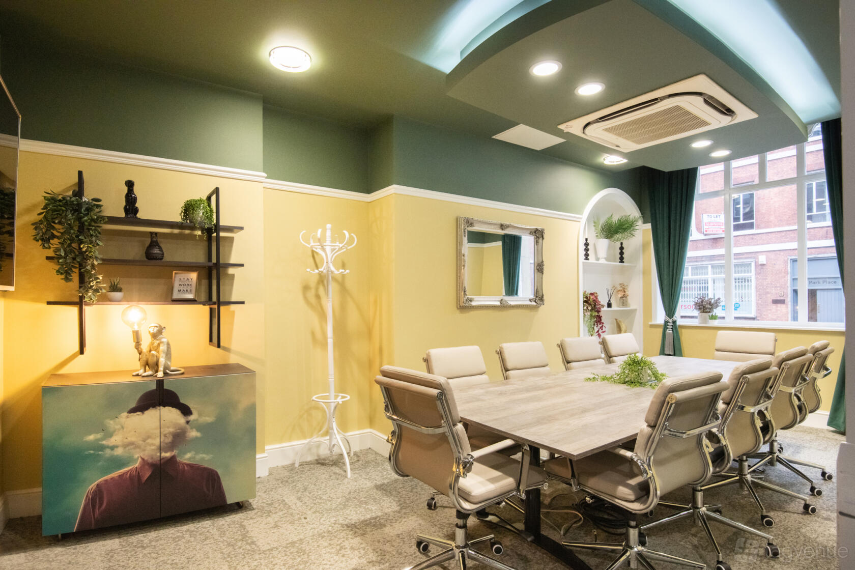 A meeting room with a long wooden table, leather chairs, large window, and eclectic decor at Wizu Workspace - Leeds - Park Place.