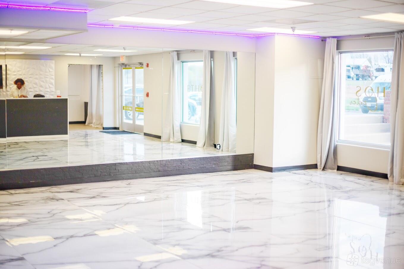 A community centre with marble flooring, mirrored wall, large windows, and purple LED lighting at The Ethos Center Events.