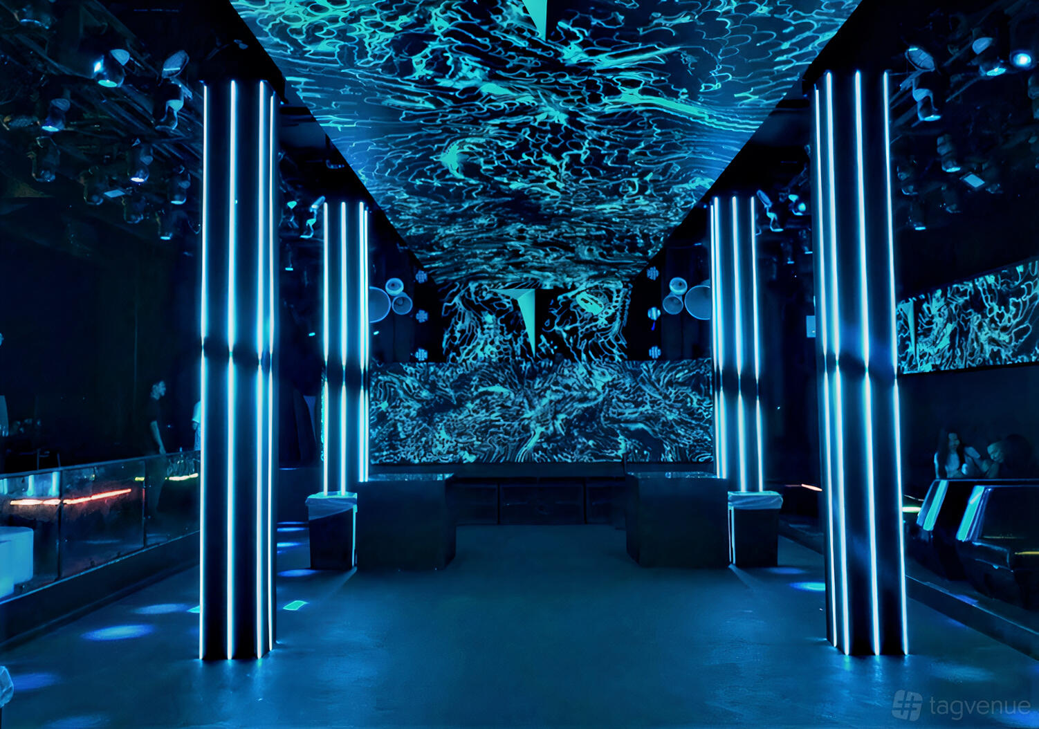 A nightclub with illuminated vertical columns, LED-lit ceiling panels, and a spacious dance floor at Zen Compound.