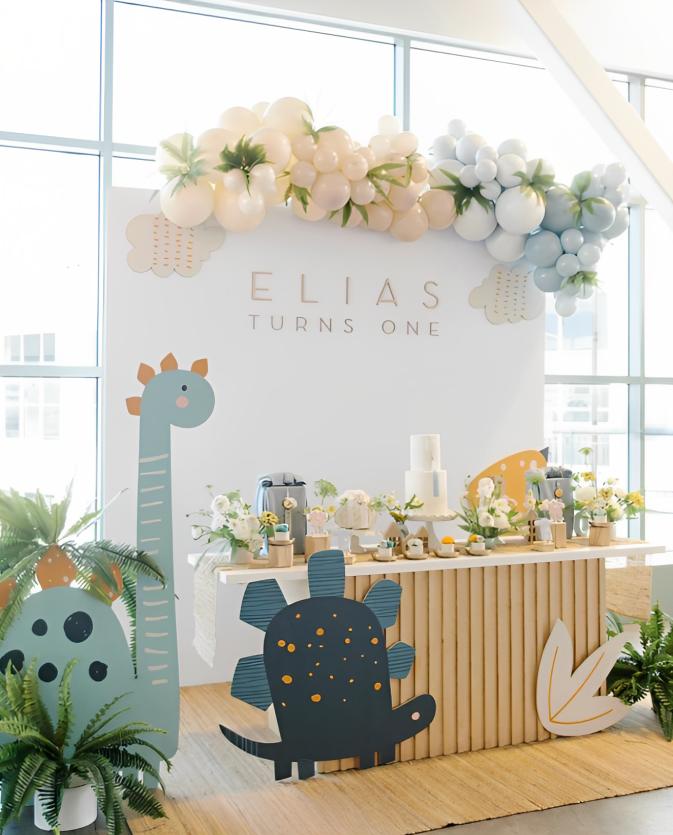 An event venue with floor-to-ceiling windows, pastel balloon décor, and a decorated dessert table at Union Market.
