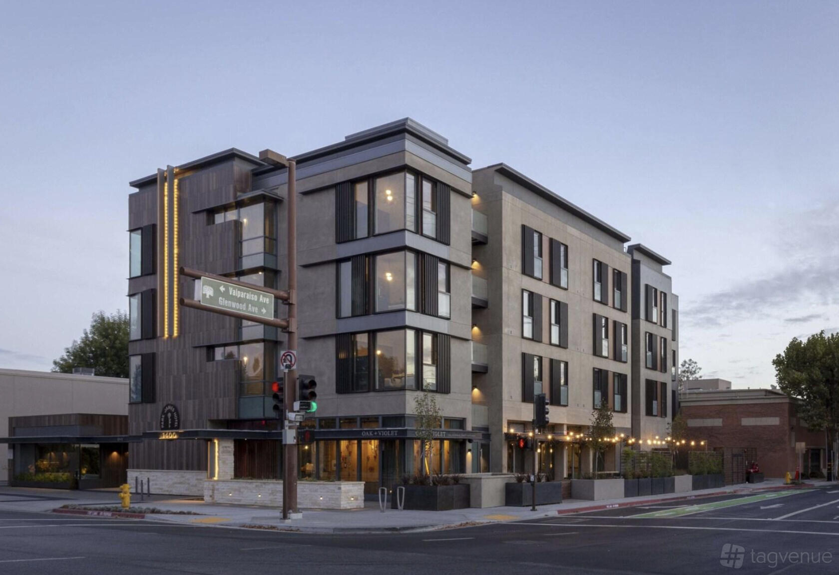 A modern hotel building with large windows and exterior lighting at Park James Hotel.