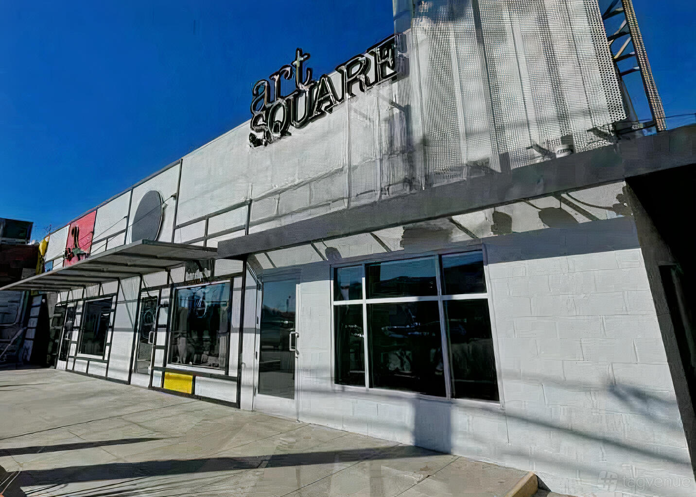 A meeting centre with a white brick exterior, large windows, and metal awning at Suite 150.