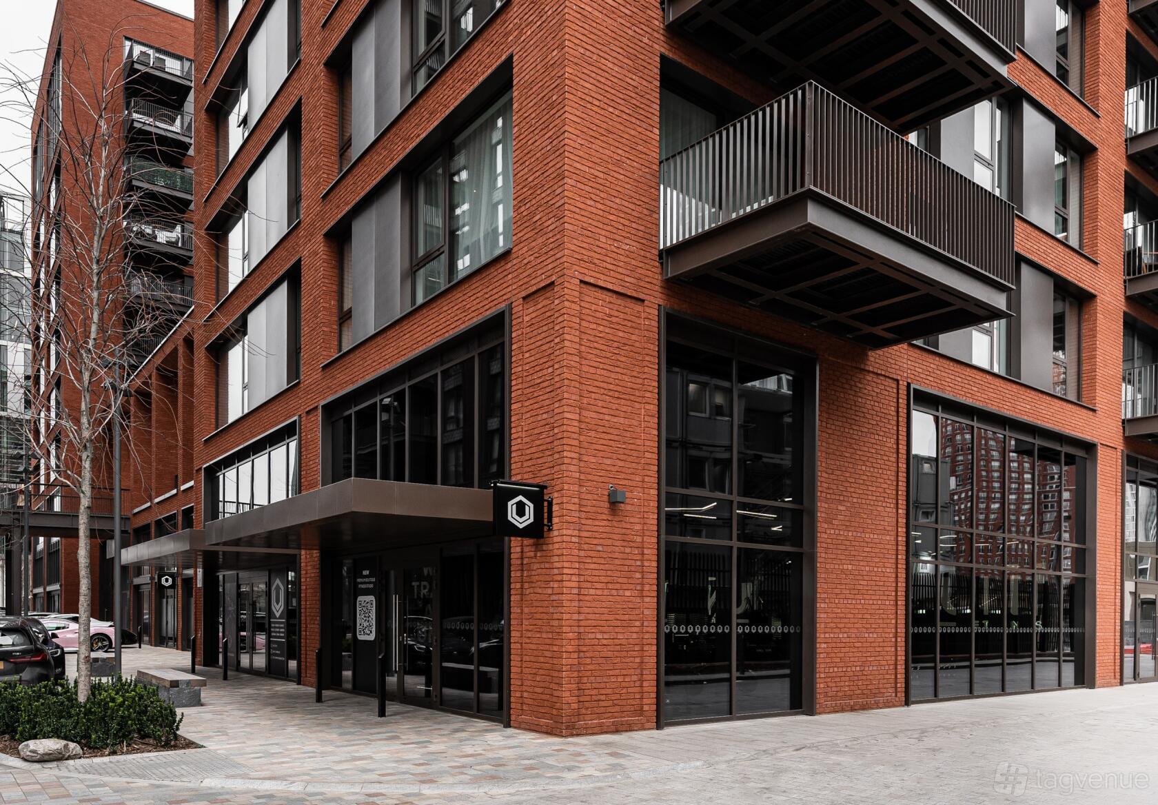A versatile event space with floor-to-ceiling windows and red brick exterior at UN1T NineElms.