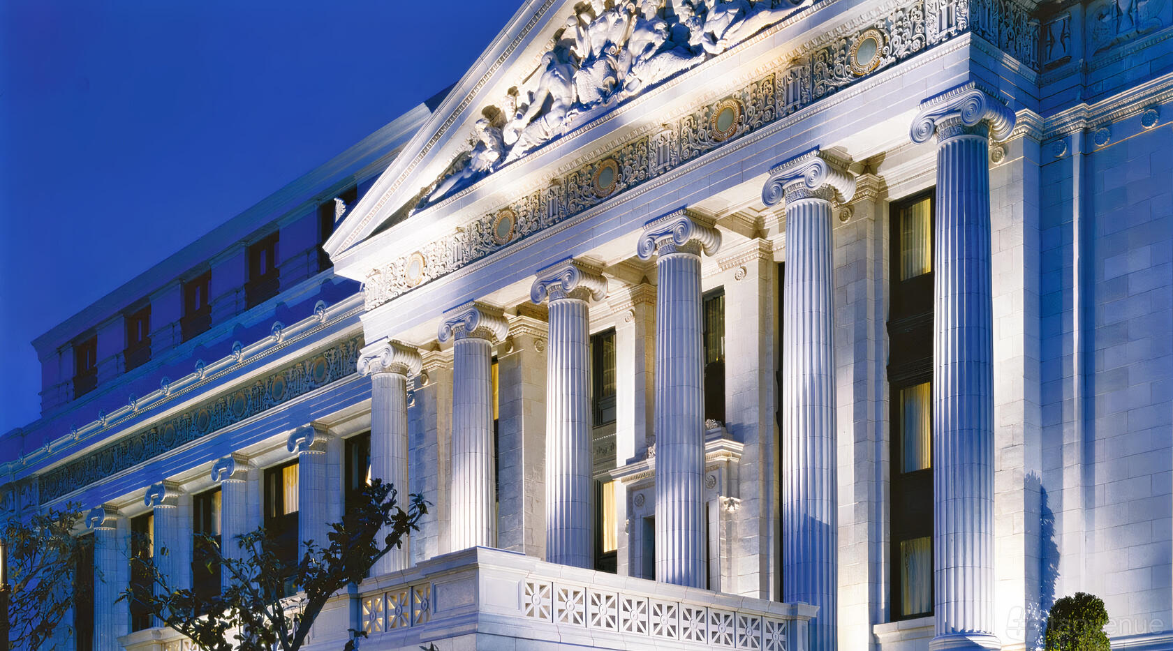 A hotel with neoclassical columns and ornate stone facade at The Ritz-Carlton San Francisco.