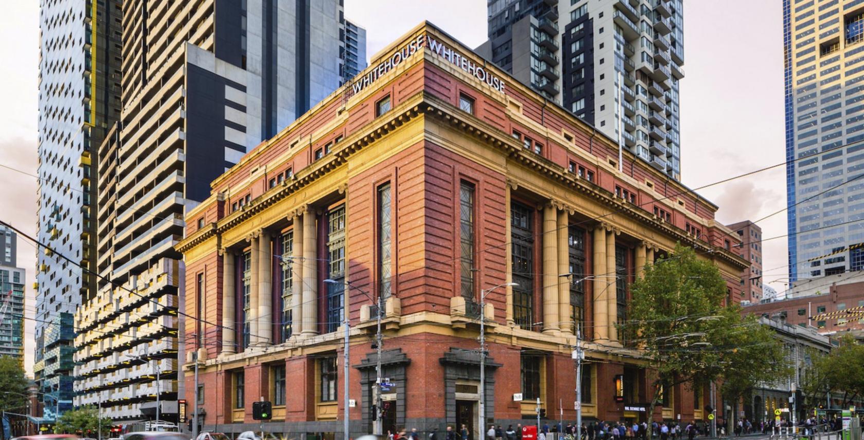 A meeting centre in a historic brick building with large windows and decorative stonework at Hub Southern Cross.