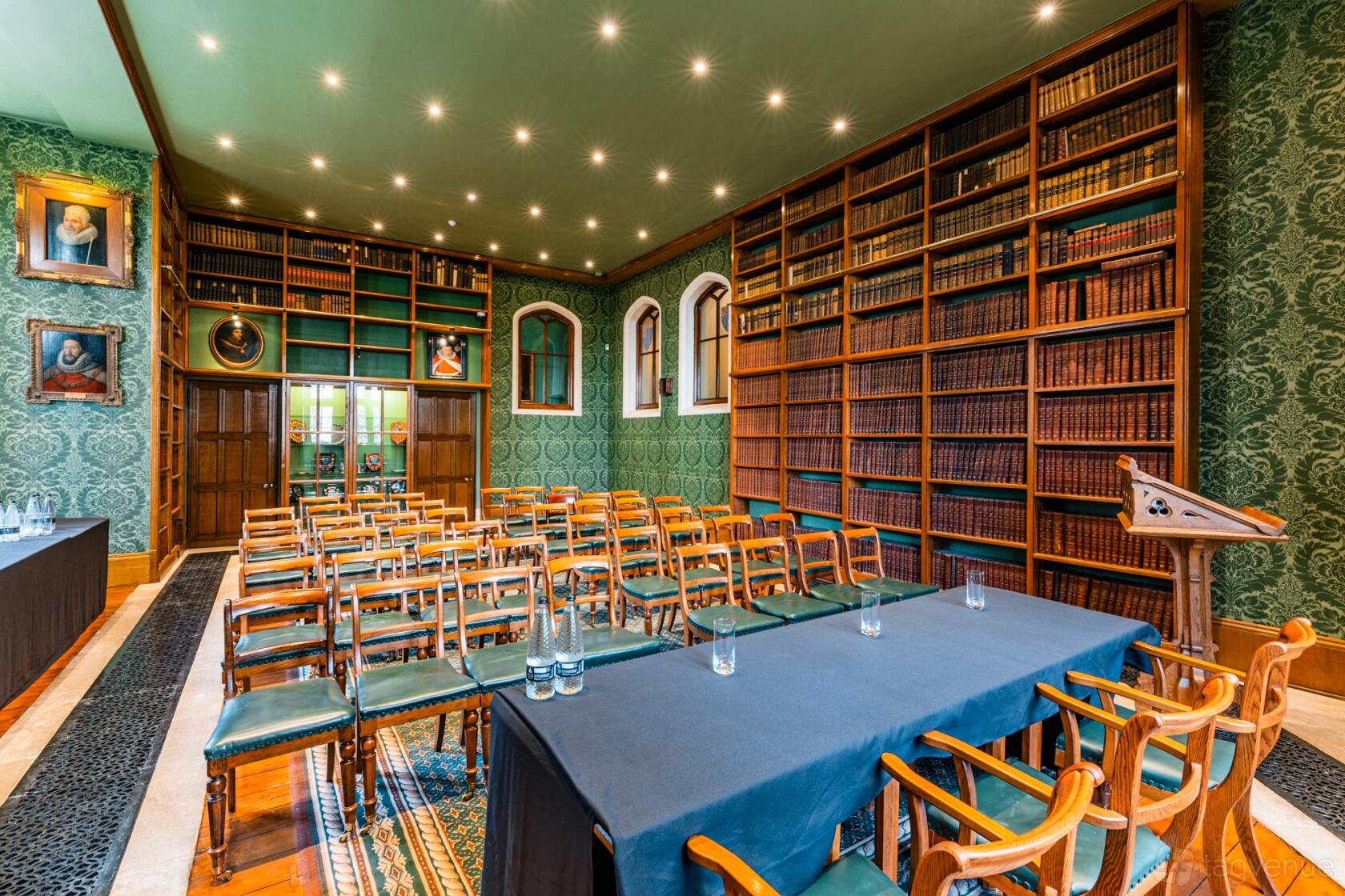 An event space with floor-to-ceiling bookshelves, vintage portraits, and rows of wooden chairs at The Honourable Society of Lincoln's Inn.