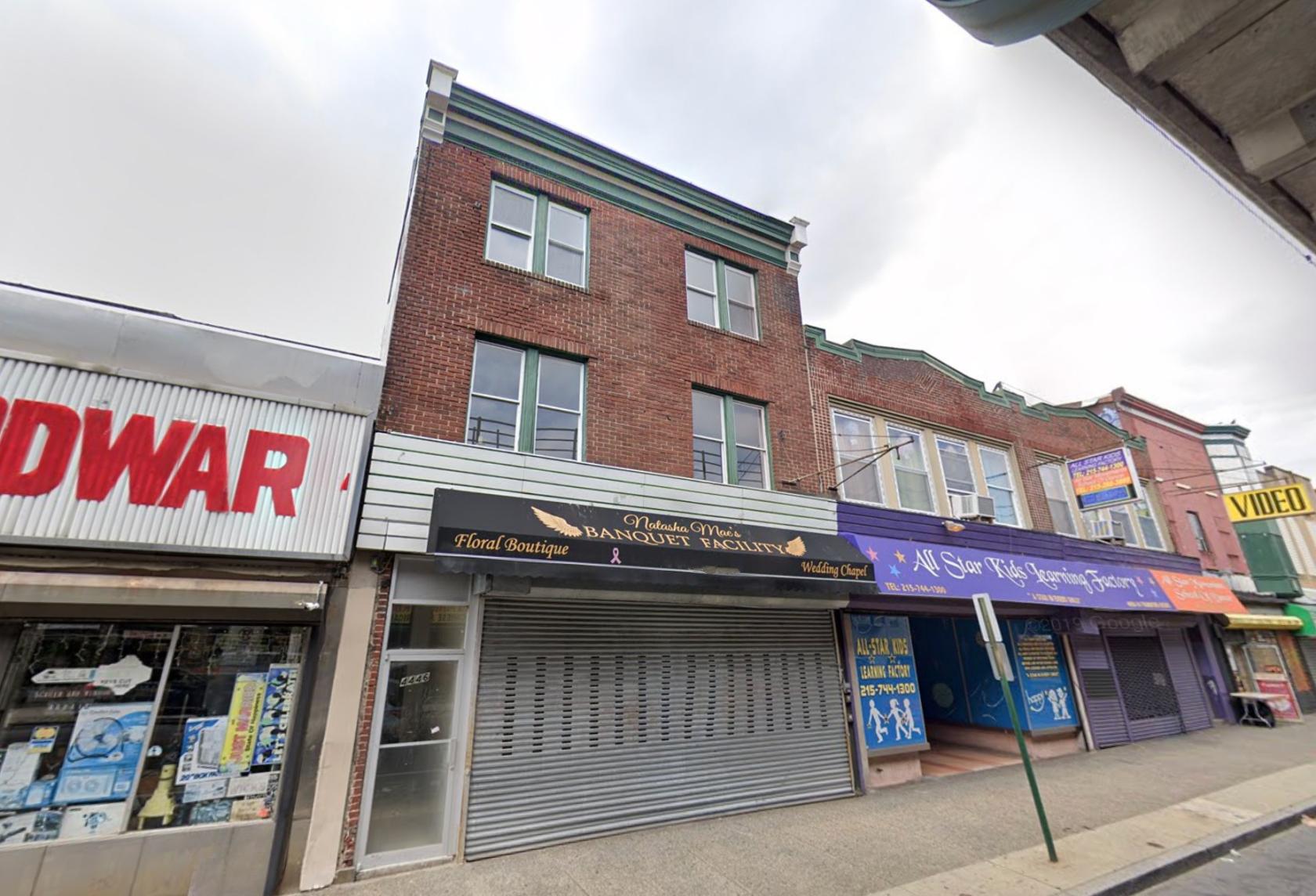 A brick versatile event space with a shuttered storefront and awning signage at Natasha Mae's Banquet Facility