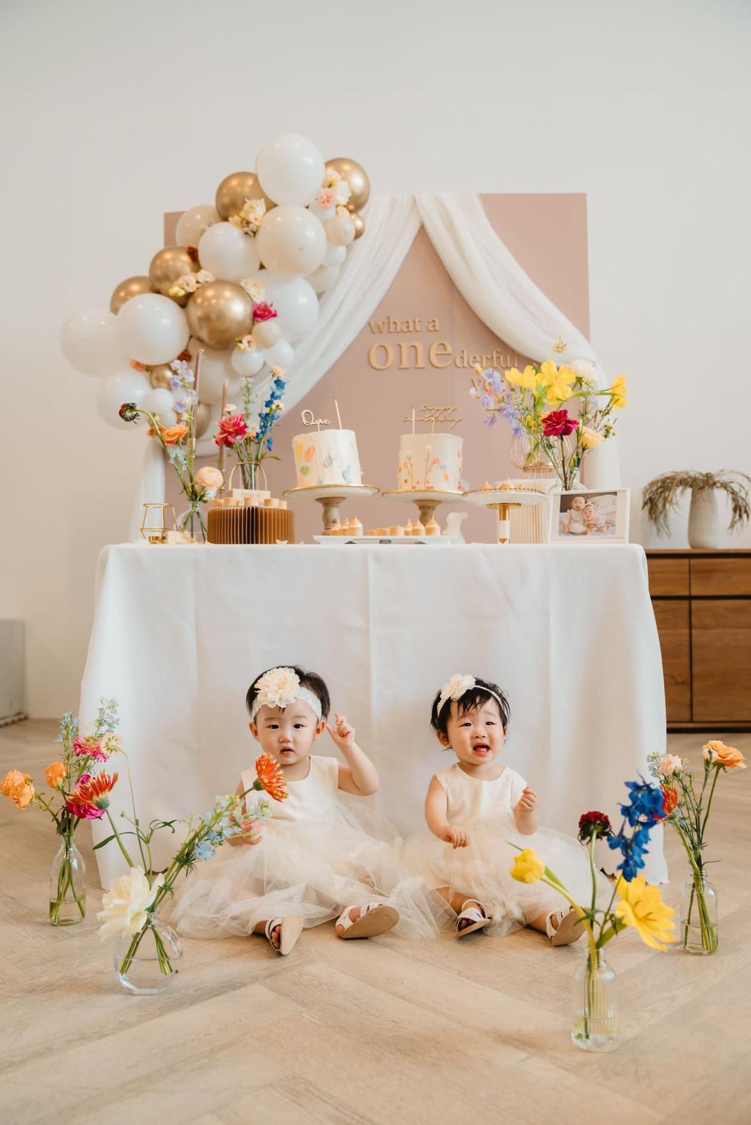A photo studio with a styled dessert table, cakes, pastel balloons, and floral arrangements at Studio Arcadia | Kitchen Studio.