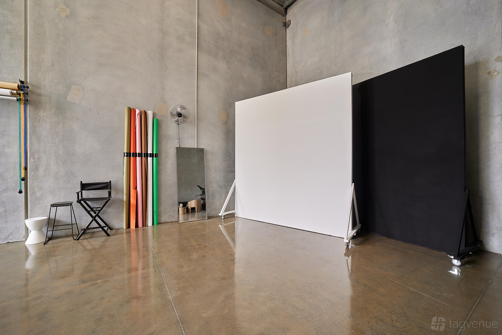 A photo studio with seamless paper backdrops, concrete walls, and polished floors at Recap Studio.