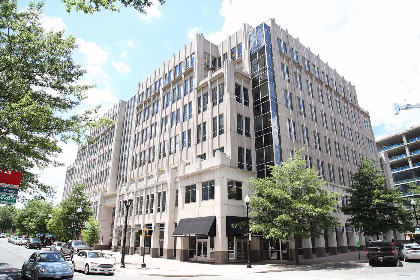 An office building with large windows, modern facade, and street view at Venture X Arlington - Courthouse Metro.