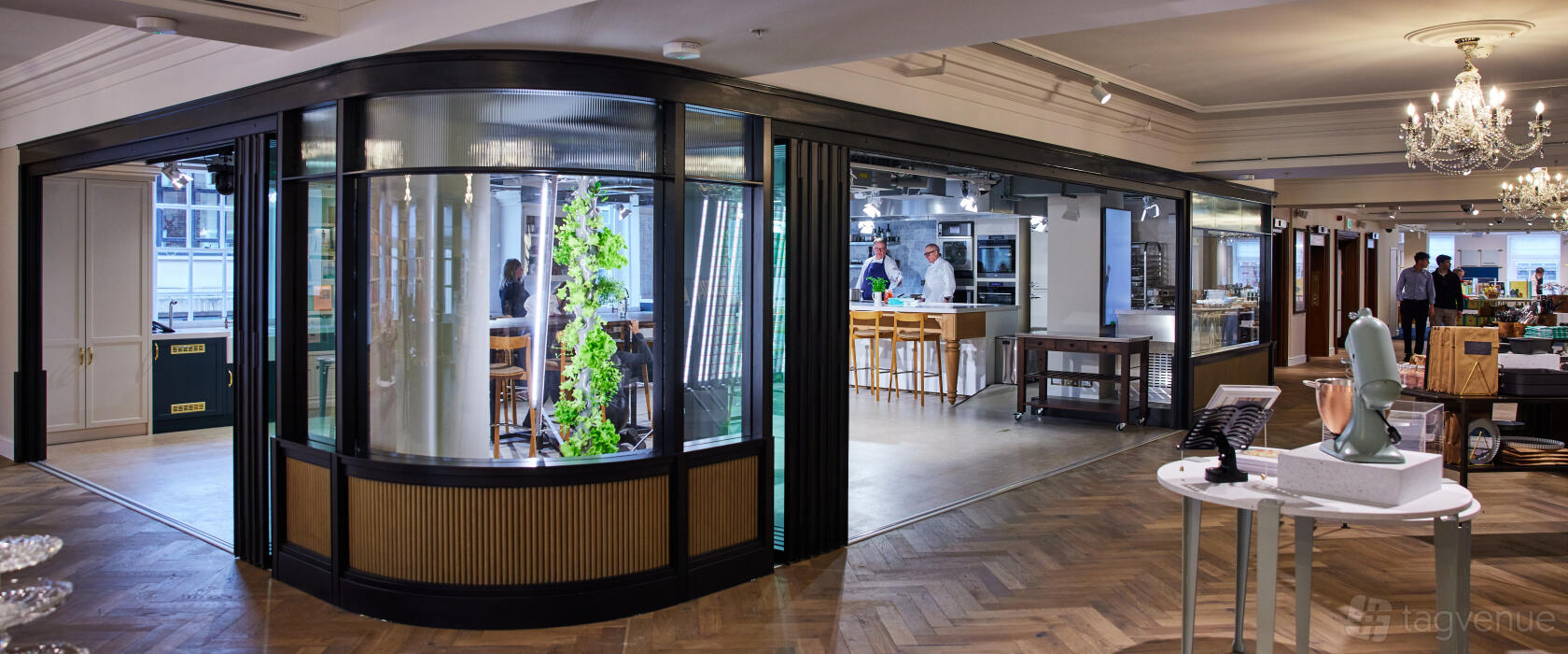 An event venue with an open kitchen, wooden flooring, and floor-to-ceiling windows at Fortnum & Mason.
