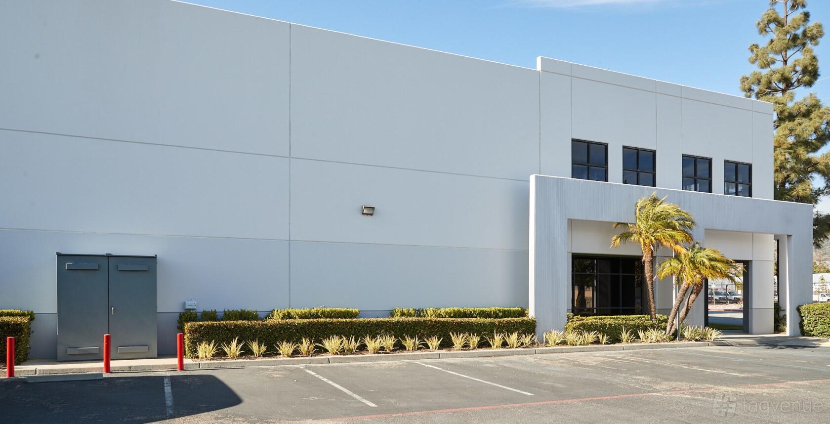 A film and photo studio with a white facade, large windows, and landscaped entry at Blackstone Entertainment.
