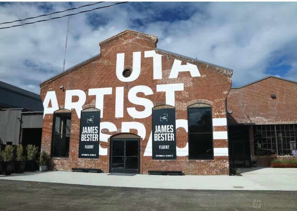 A brick warehouse with large white painted lettering and tall windows at Pullman Yards.
