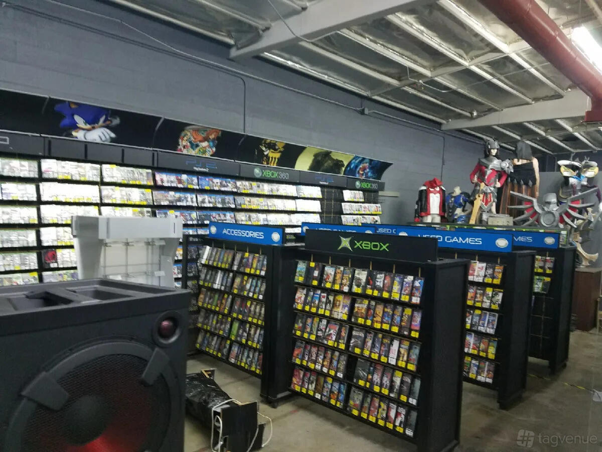 A photo studio with shelves of video games, Xbox signage, and pop culture figurines at Cosmic Cube Creative Studio.