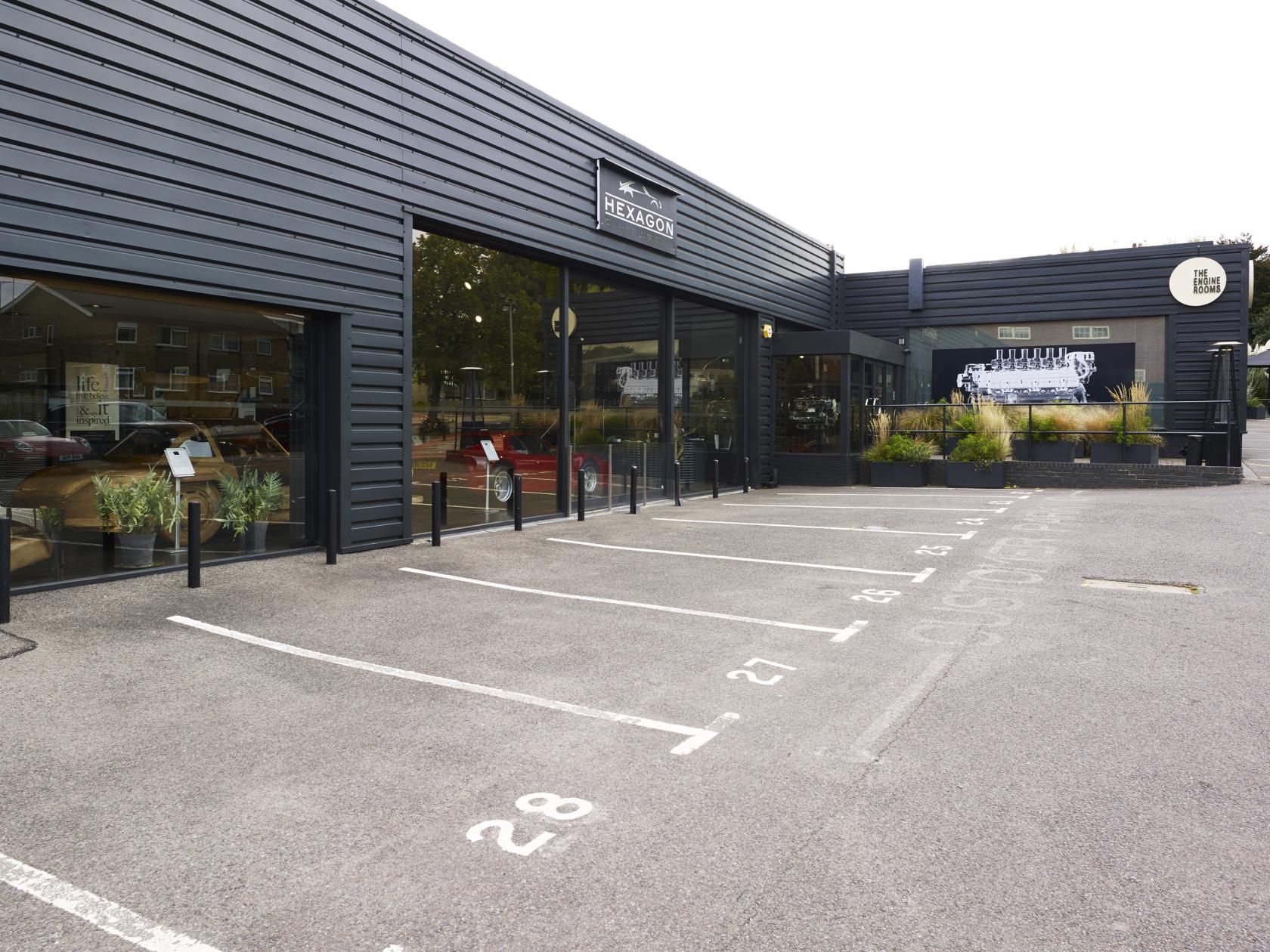 A versatile event space with black metal siding and large glass windows at The Engine Rooms Events Space.
