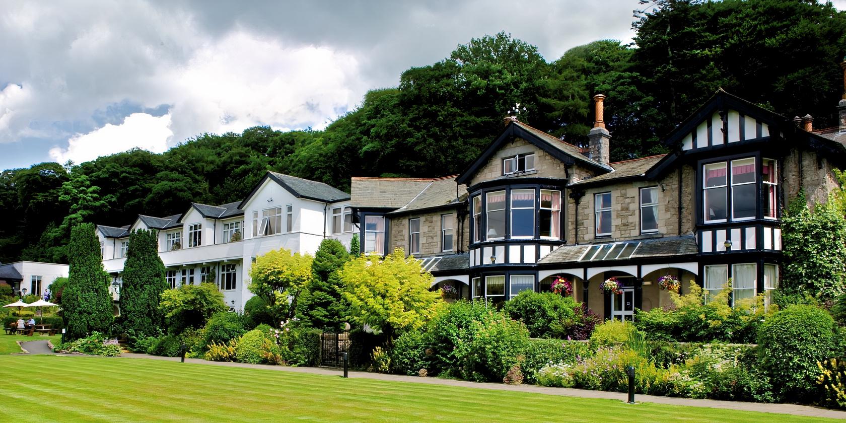A hotel with Tudor-style architecture, bay windows, and manicured lawns at Castle Green Hotel.