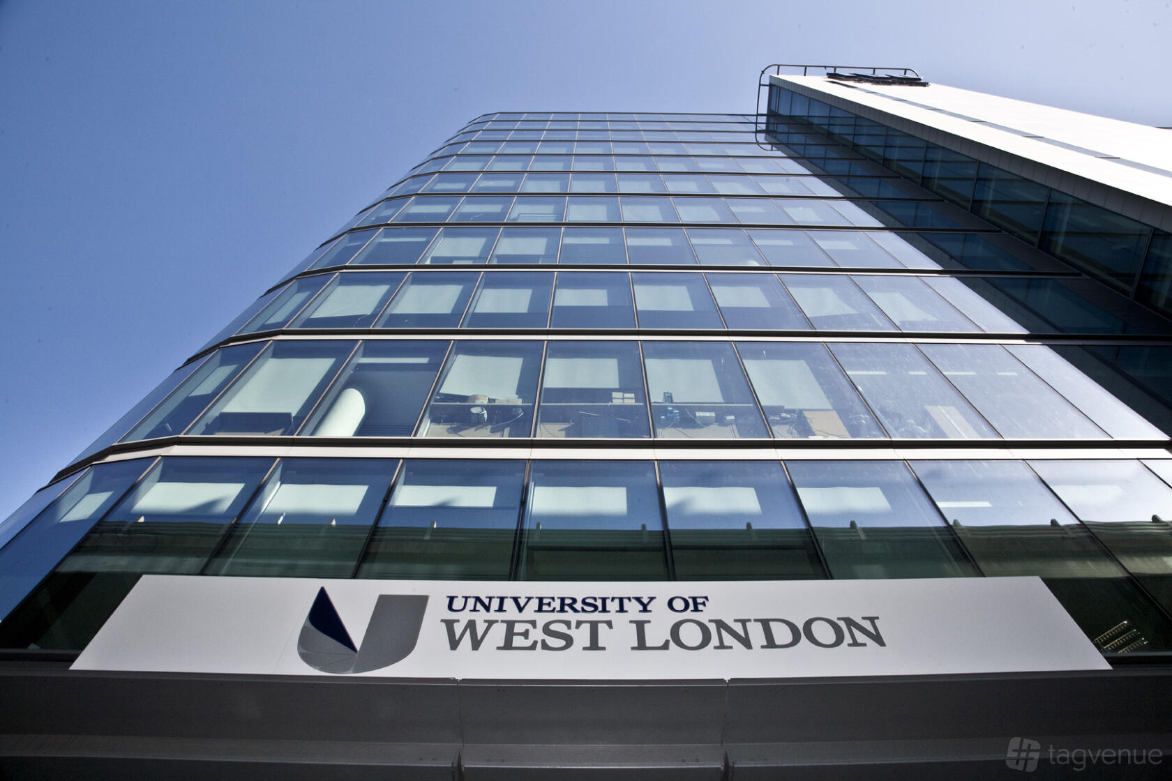 A glass-fronted academic building with large windows and University of West London signage at Paragon House.