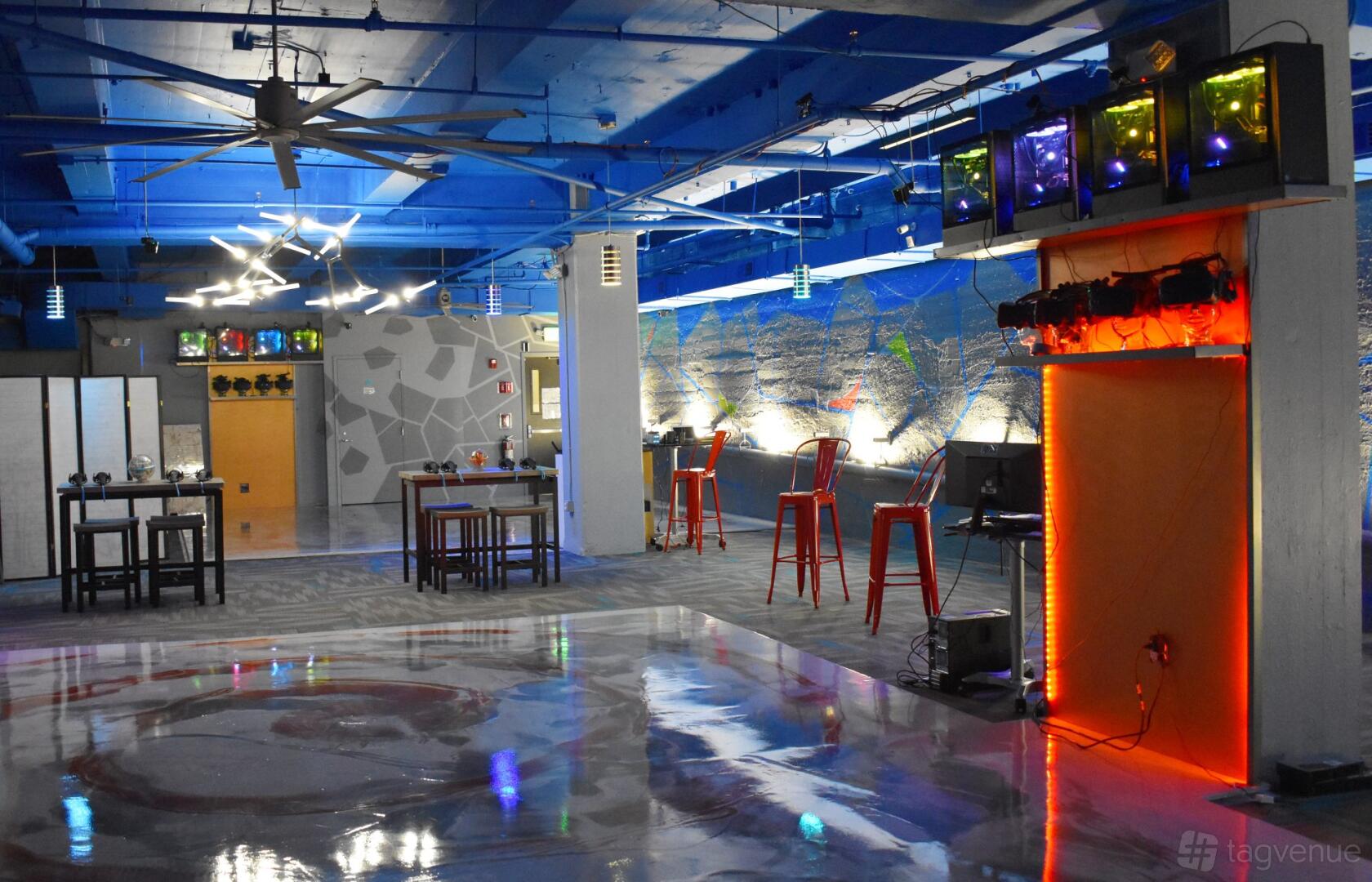 An event venue with virtual reality stations, colorful lighting, and polished floors at Key To Amaze VR.