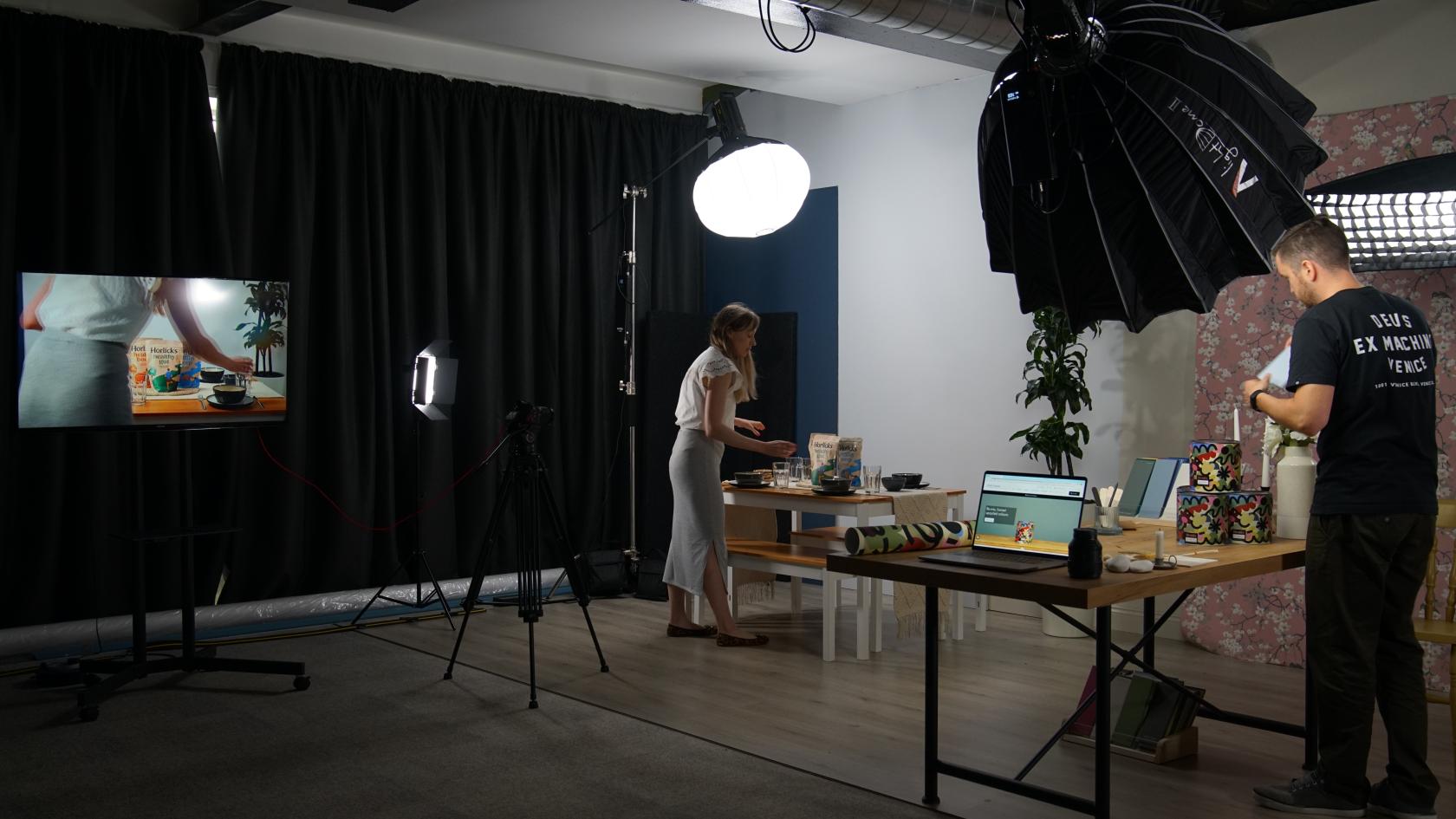 A photo studio with softbox lighting, black curtains, camera equipment, and a table setup at CTI Digital.
