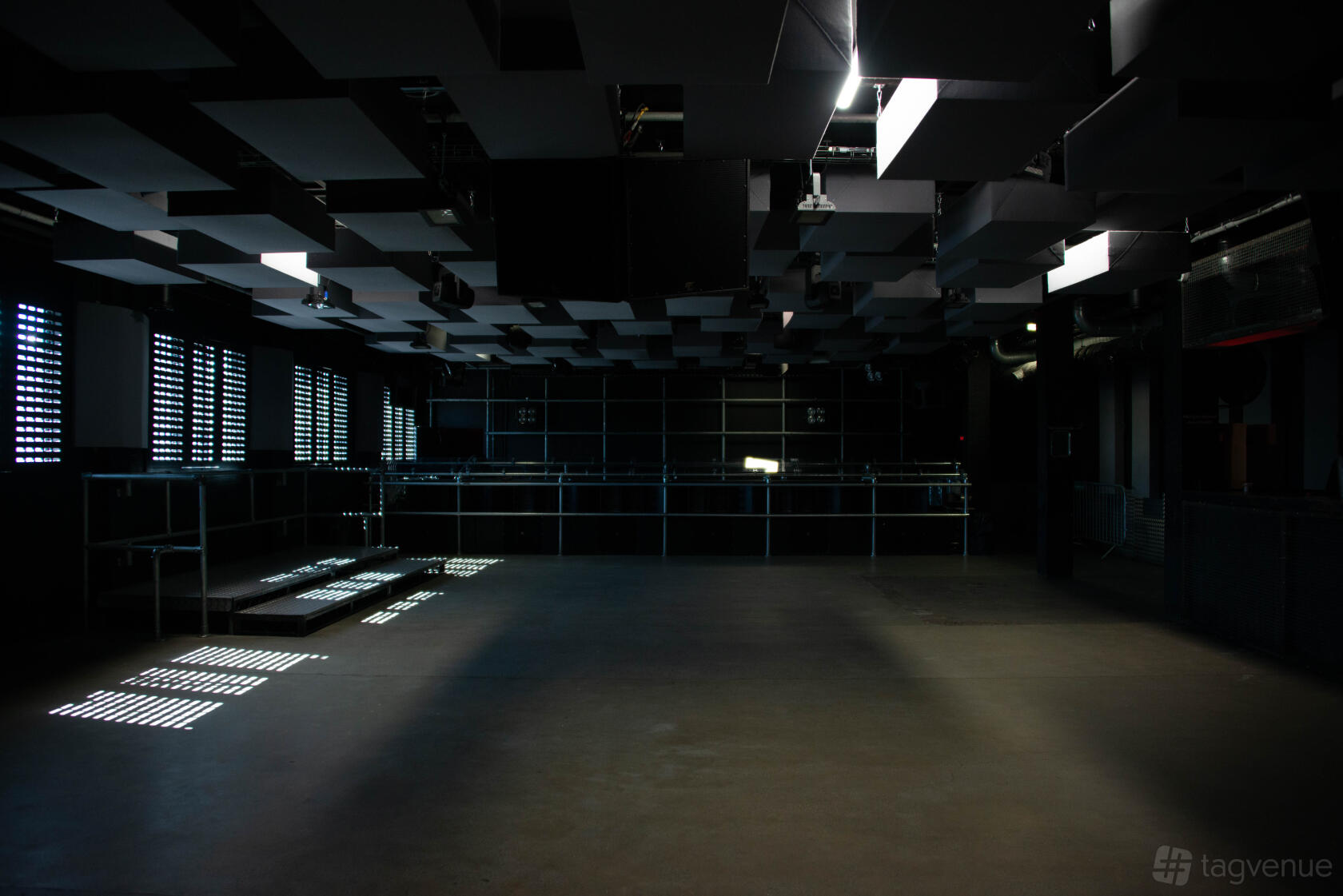 A filming location with patterned ceiling panels, concrete floors, and filtered light at FOLD.