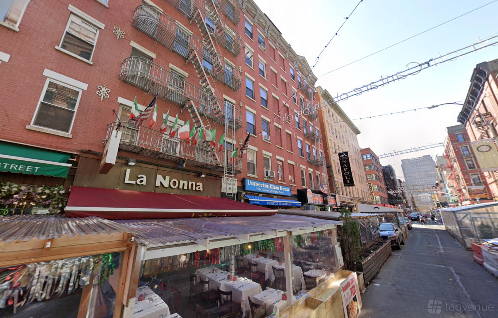 A street view of Miette Culinary Studios Inc with outdoor dining tables under a covered seating area.
