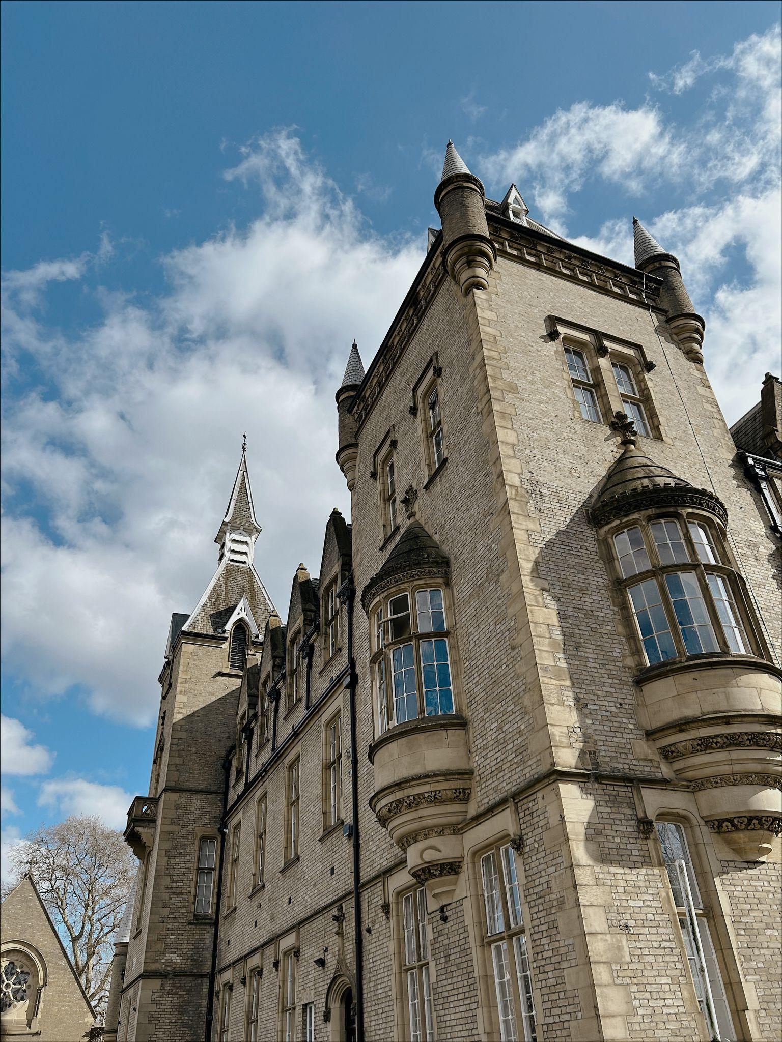 A historic stone building with tall bay windows and pointed turrets at Daylight & Natural Light Photo Studio.