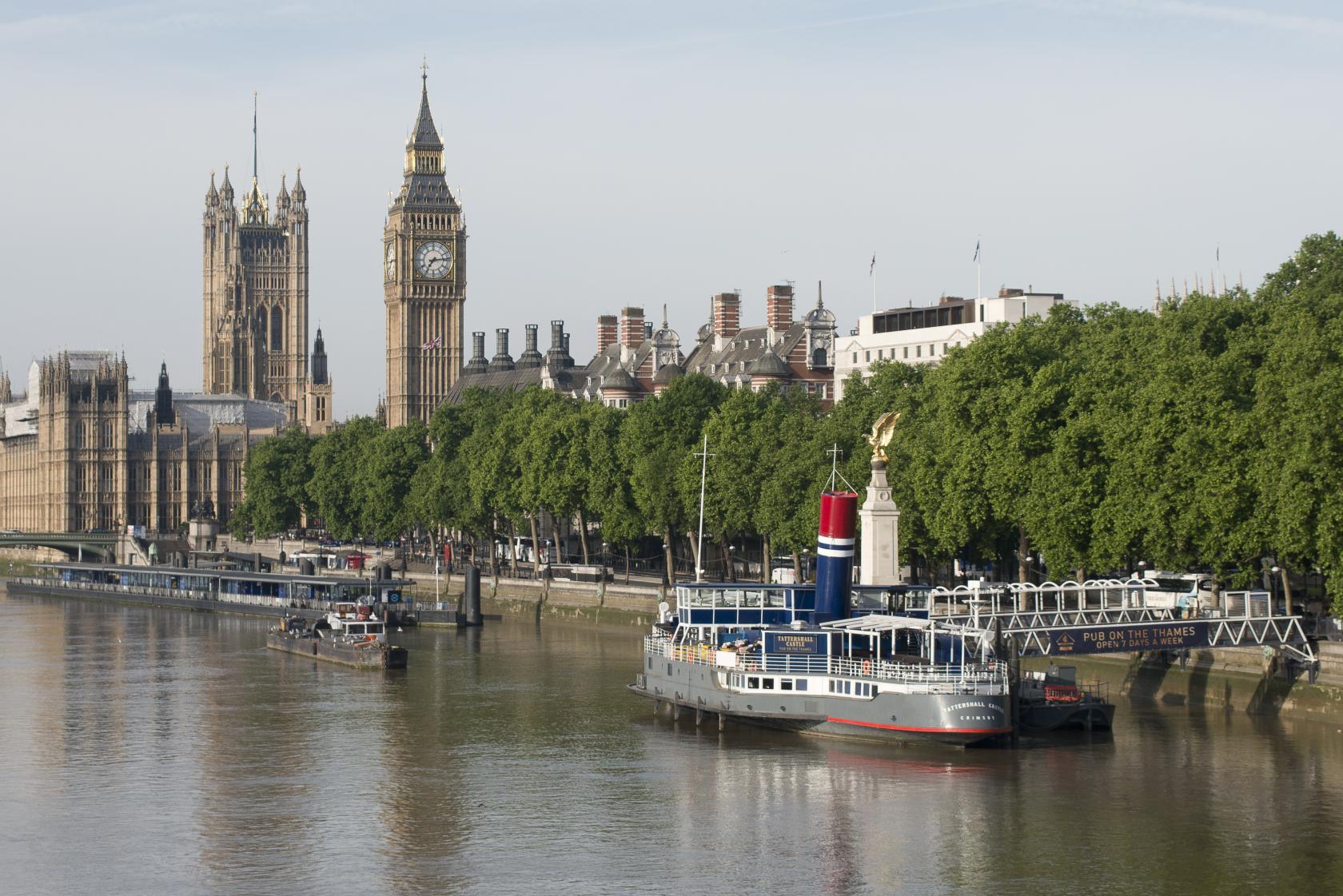 A docked boat venue with upper deck seating and river views alongside the Houses of Parliament at The Tattershall Castle.