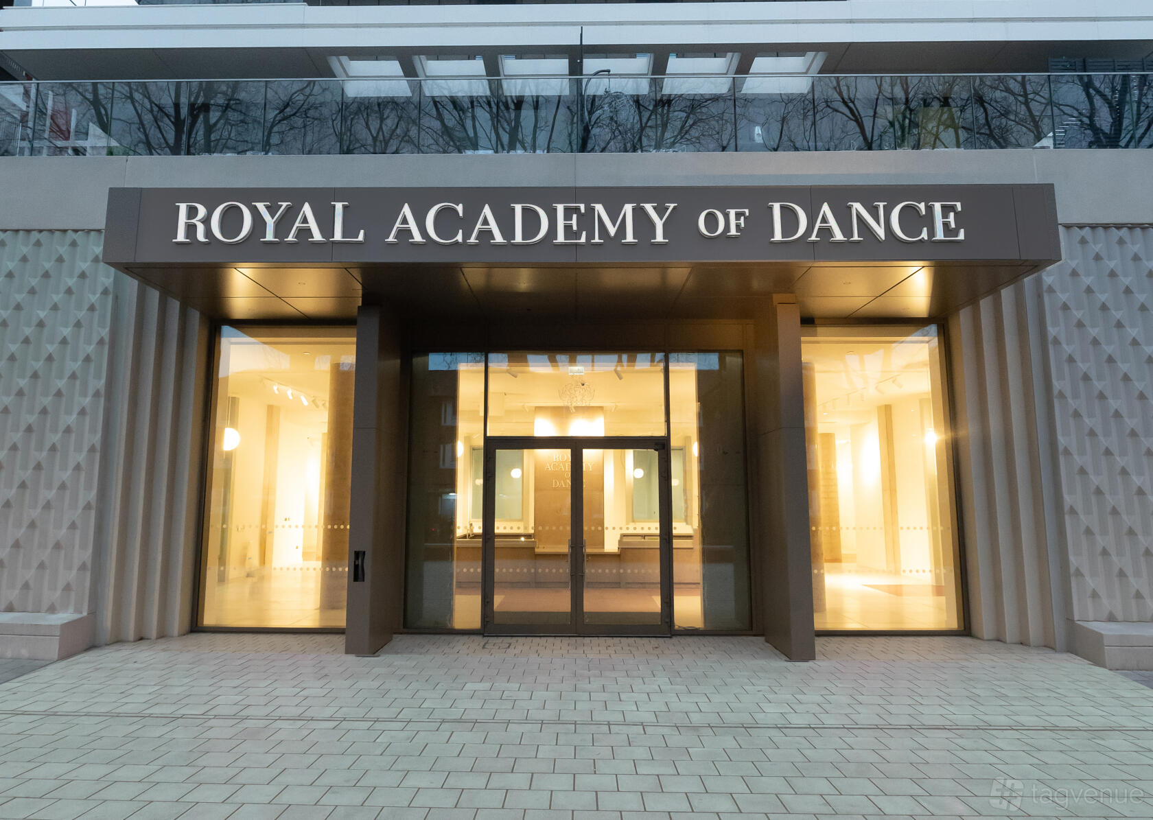 A versatile event space with large glass entrance doors and illuminated signage at Royal Academy of Dance.