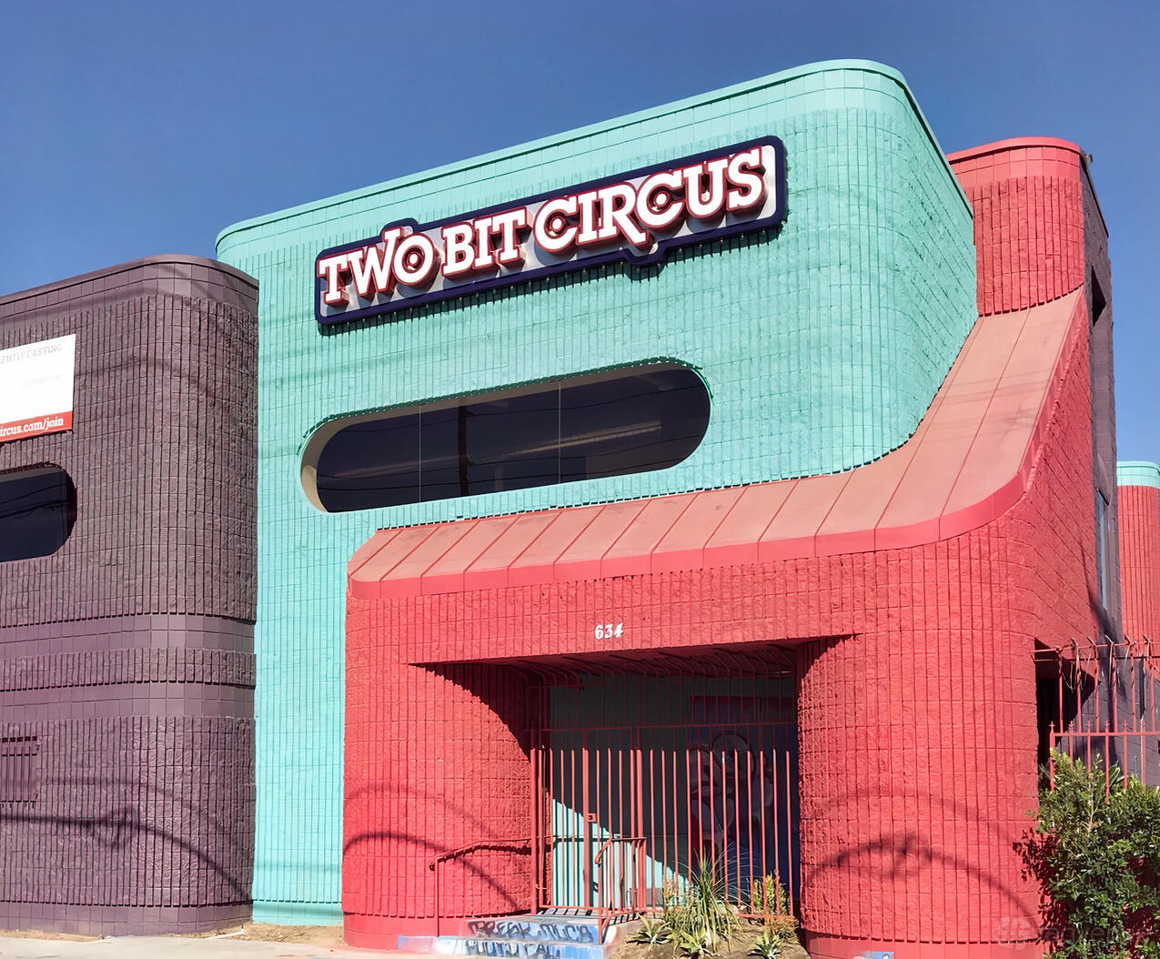 A versatile event space with colorful brick exterior and a prominent sign at Two Bit Circus.