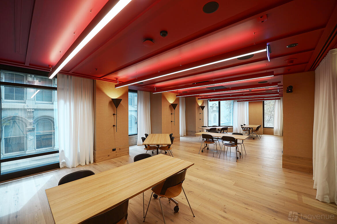 A boardroom with large windows, red ceiling panels, light wood floors, and rectangular tables at Space&Co. Queen & Collins, Melbourne.