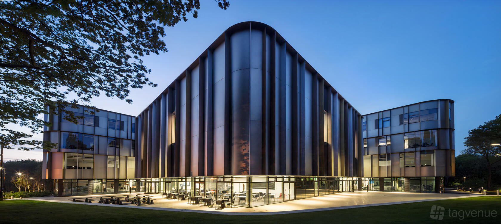 A versatile event space with a modern glass exterior and curved steel facade at University of Kent.