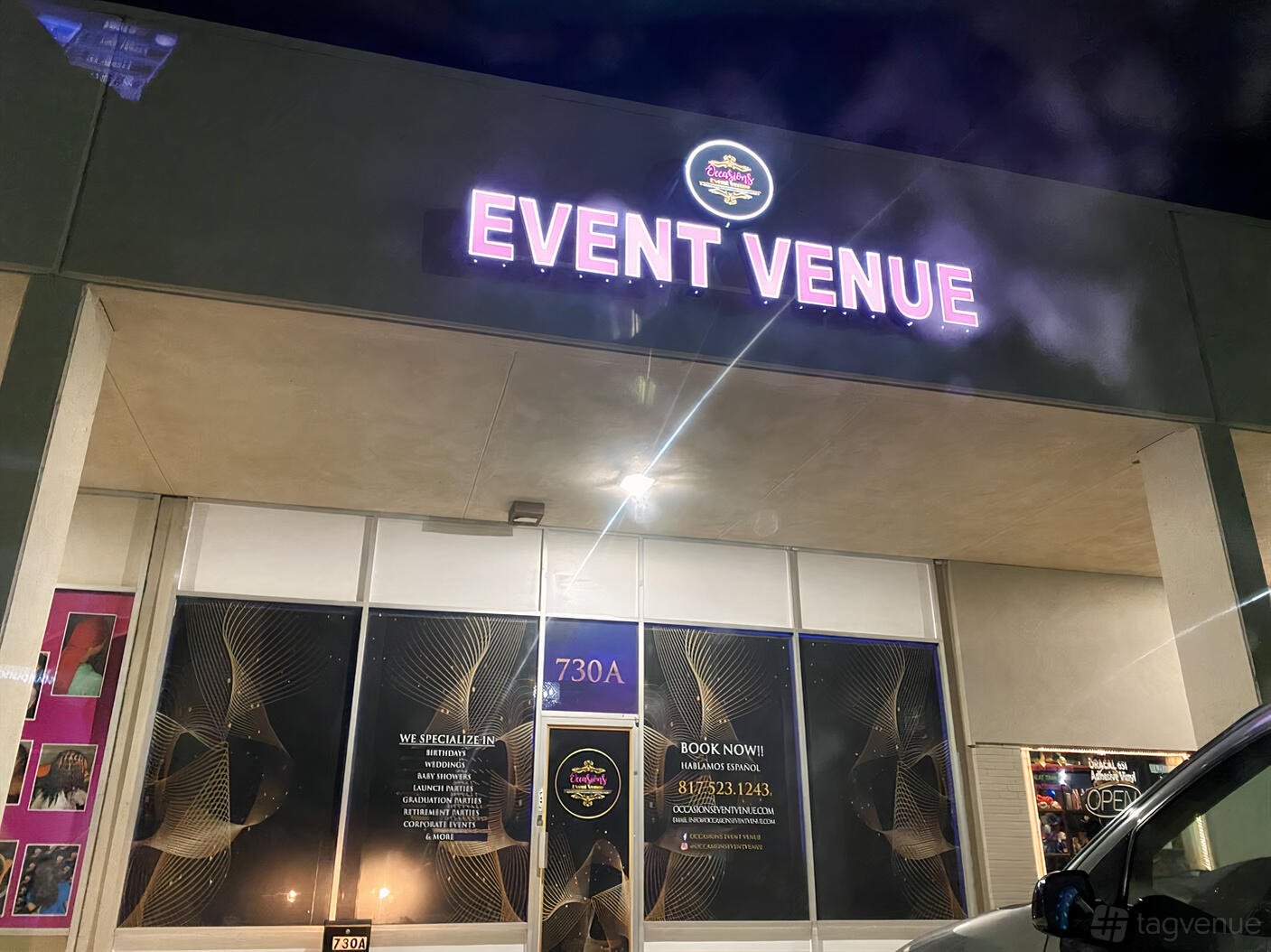 A versatile event space with a glass storefront, illuminated signage, and decorative window graphics at Occasions Event Venue.