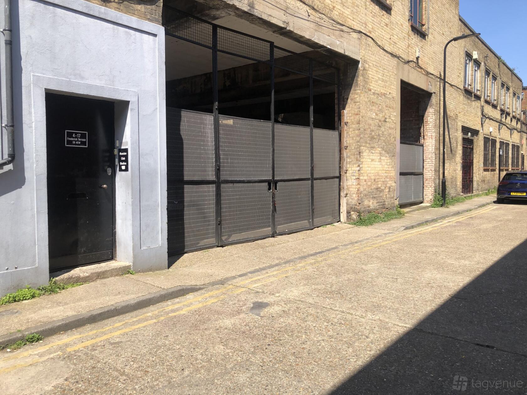 A film and photo studio with an industrial brick exterior and large metal doors at Frederick Terrace.