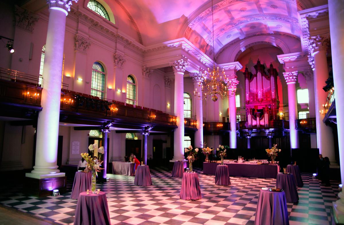 An event venue with high vaulted ceilings, checkered marble floors, and classical columns at Sinfonia Smith Square.