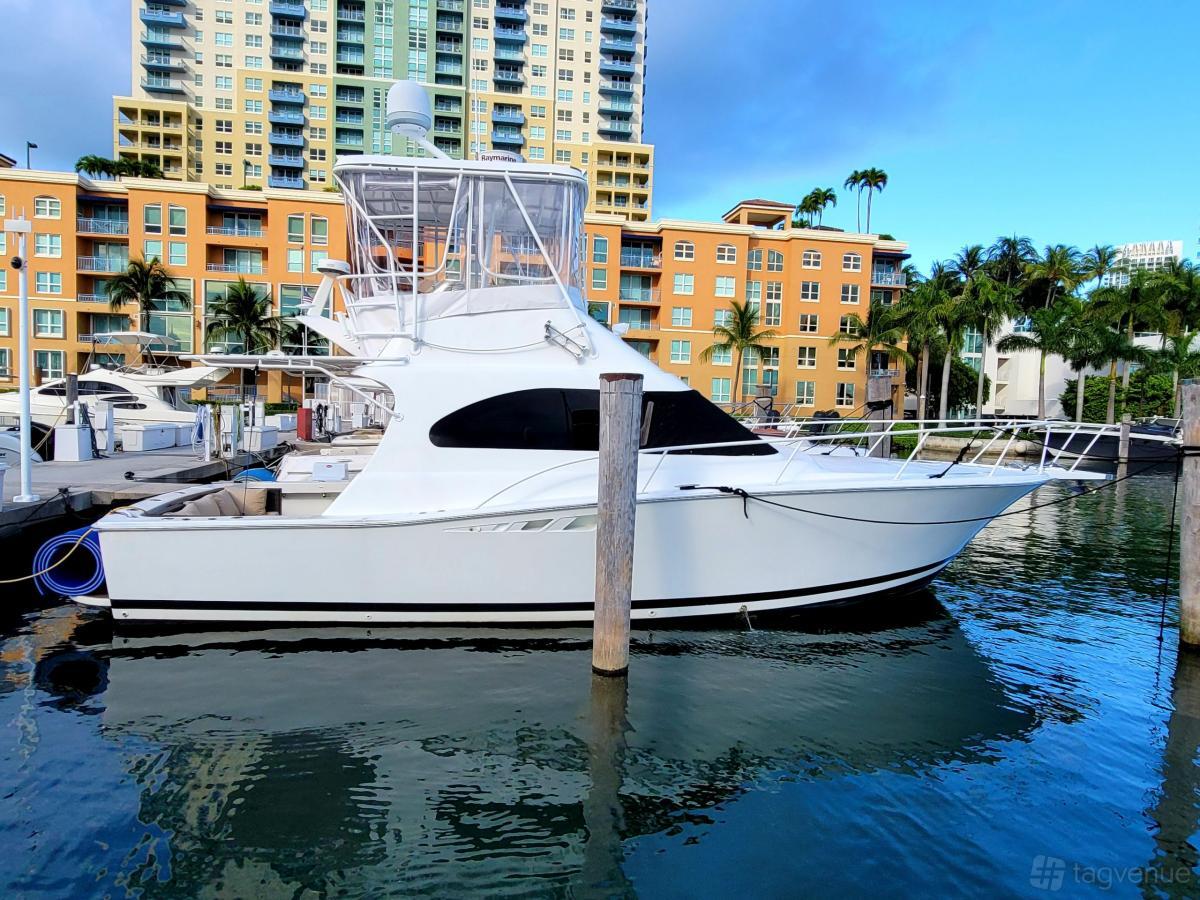 A docked white yacht with tinted windows and an upper deck at Ocean View Yacht Charters.