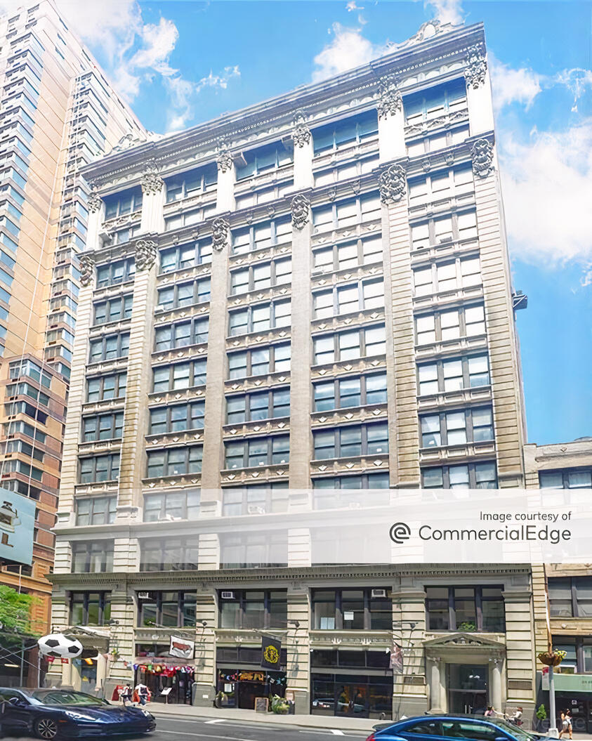 An exterior of a multi-story film and photo studio with large grid windows and ornate detailing at Video Photo Studio.