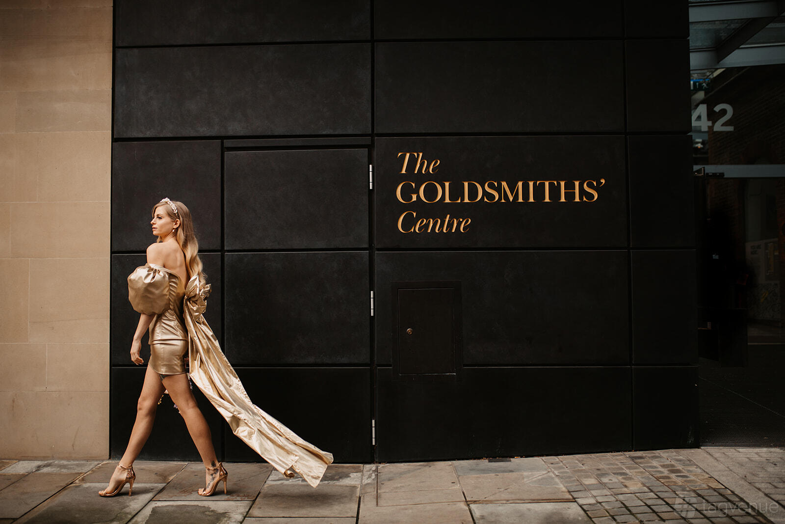 A conference centre with a dark exterior wall featuring gold signage at The Goldsmiths' Centre.