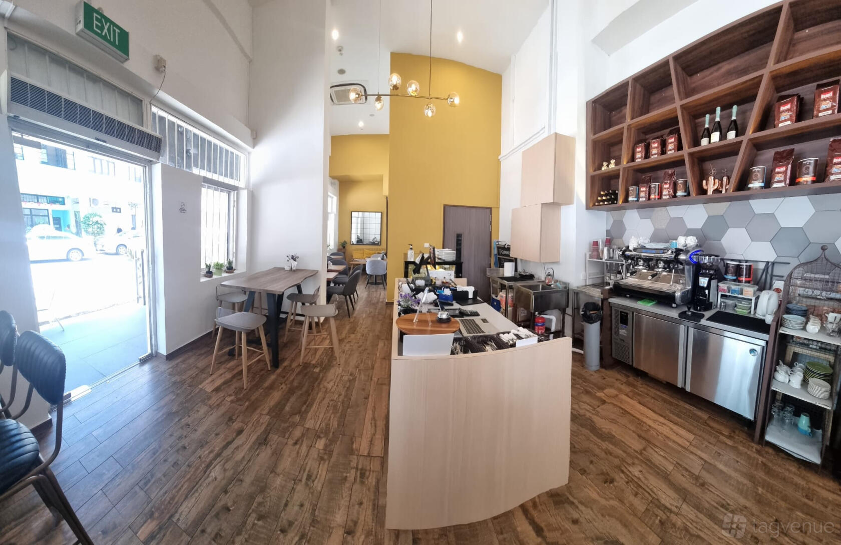 A cafe with wooden floors, white walls, open shelving, and a coffee counter at Tyrwhitt Little Cafe.