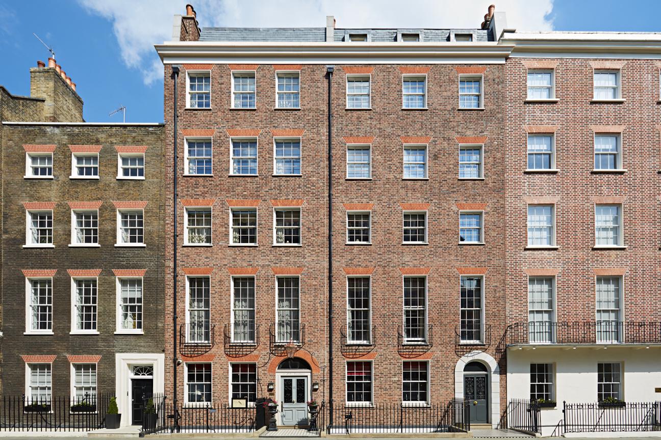 A hotel with a red brick Georgian facade and tall sash windows at The Zetter Marylebone.